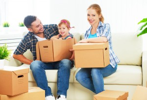 moving to new home. Happy family with cardboard boxes and Palm State Mortgage. 